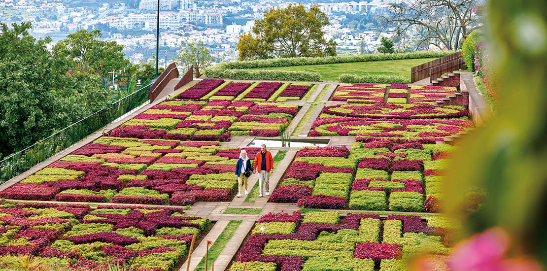 A couple walking through Funchal's botanical gardens